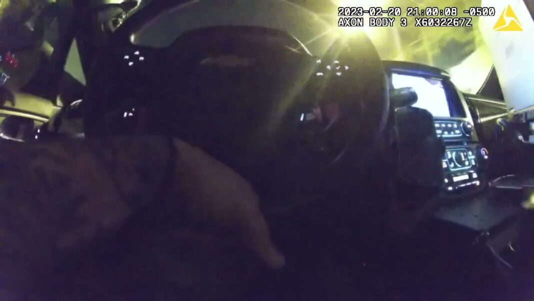 Bodycam Footage: Suspect Arrested After Alledged Robbery Police body camera footage showing car interior at night.